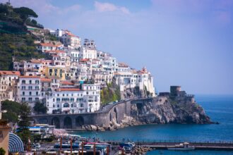 Amalfi Coast viewed from a ferry with cliffs and coastal villages