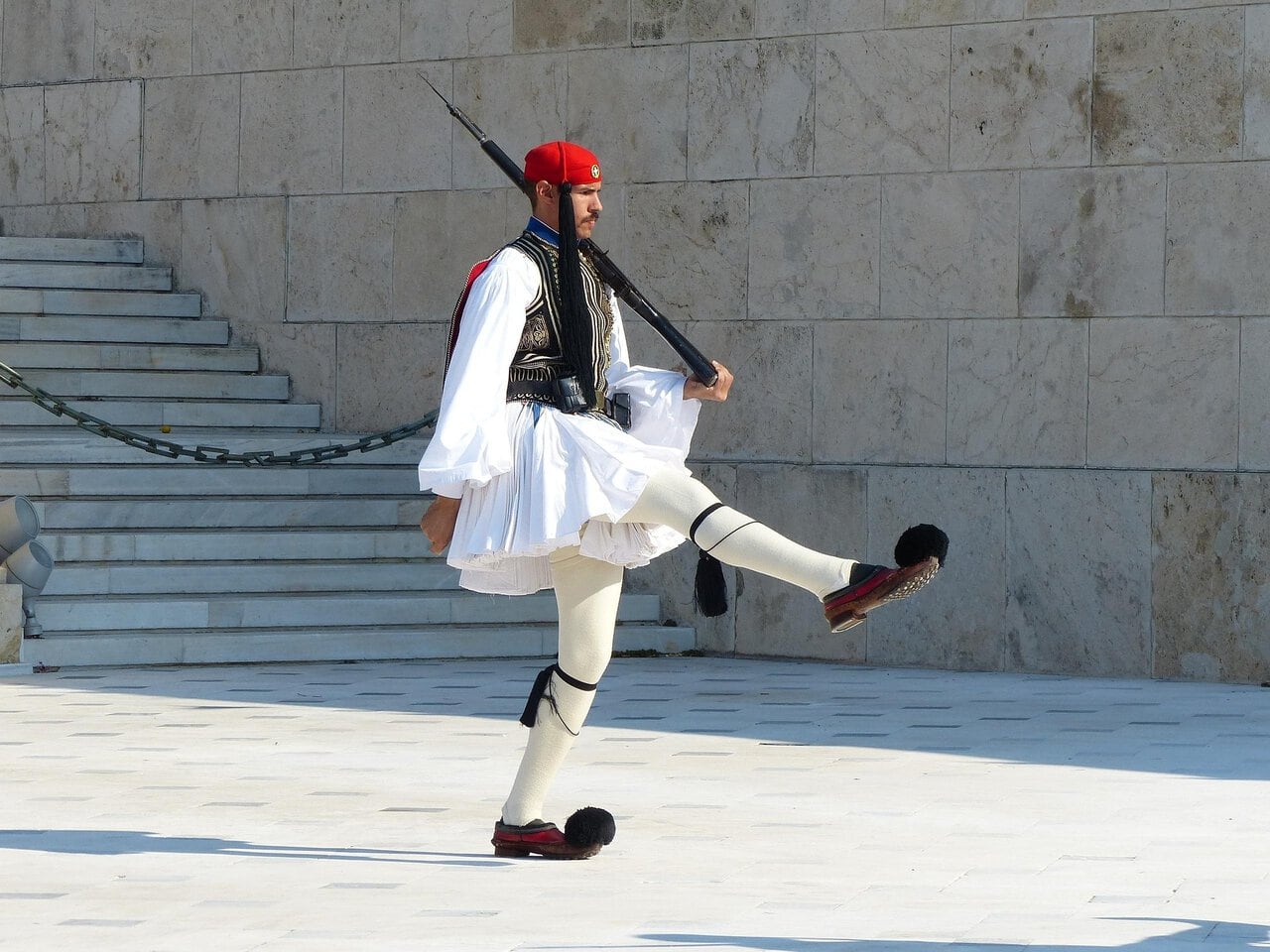 An Evzone ceremonial guard marching outside the Greek Parliament in Athens.