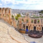 The Odeon of Herodes Atticus beneath the Acropolis with Athens stretching across the background.