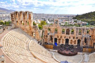 The Odeon of Herodes Atticus beneath the Acropolis with Athens stretching across the background.