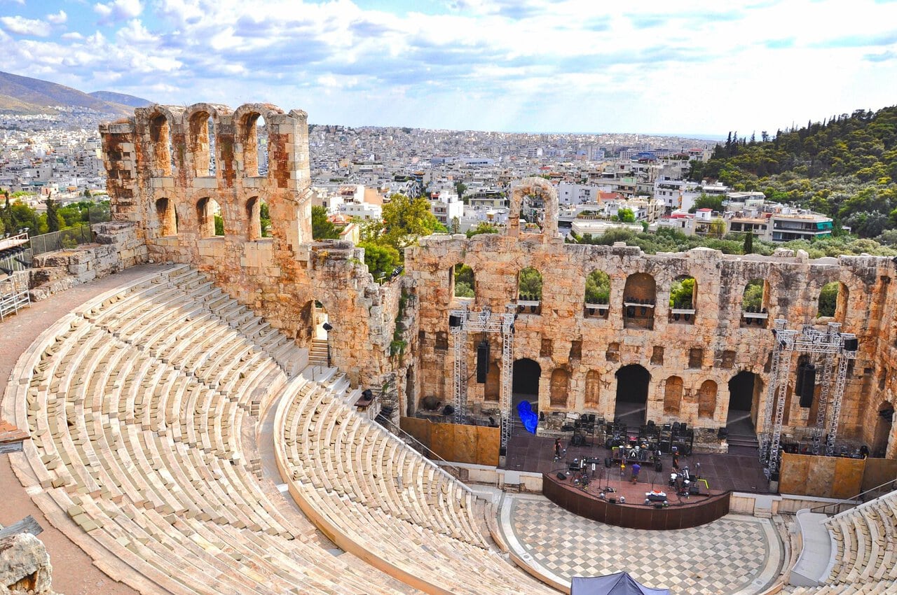 The Odeon of Herodes Atticus beneath the Acropolis with Athens stretching across the background.