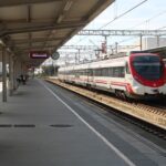 Renfe commuter train waiting at a railway station in Spain