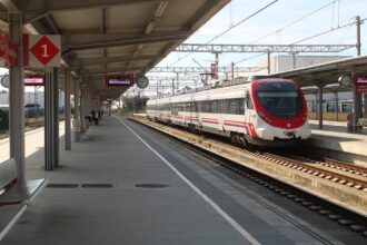 Renfe commuter train waiting at a railway station in Spain