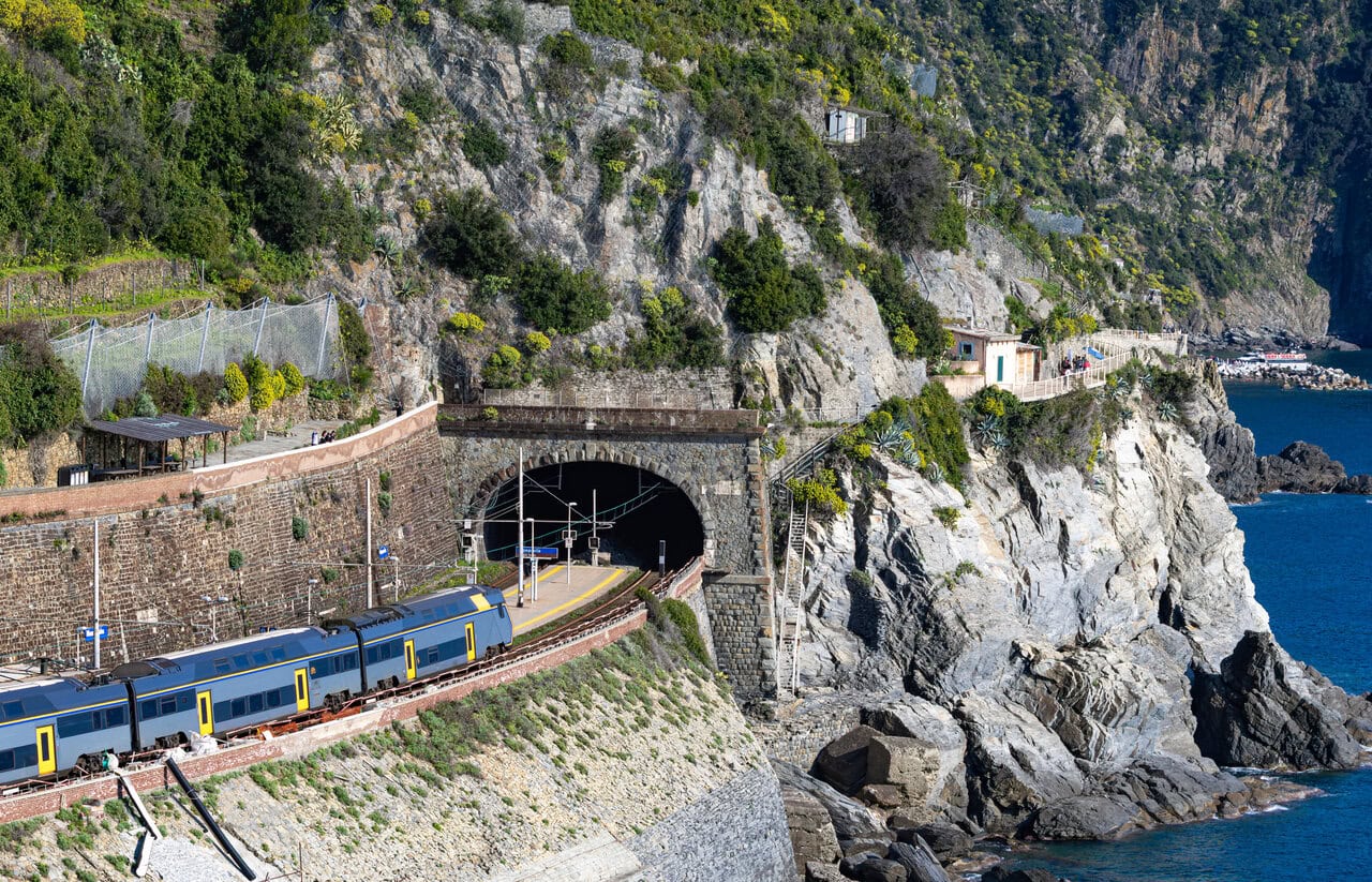 Train travelling through the dramatic coastal railway at Riomaggiore in Cinque Terre.