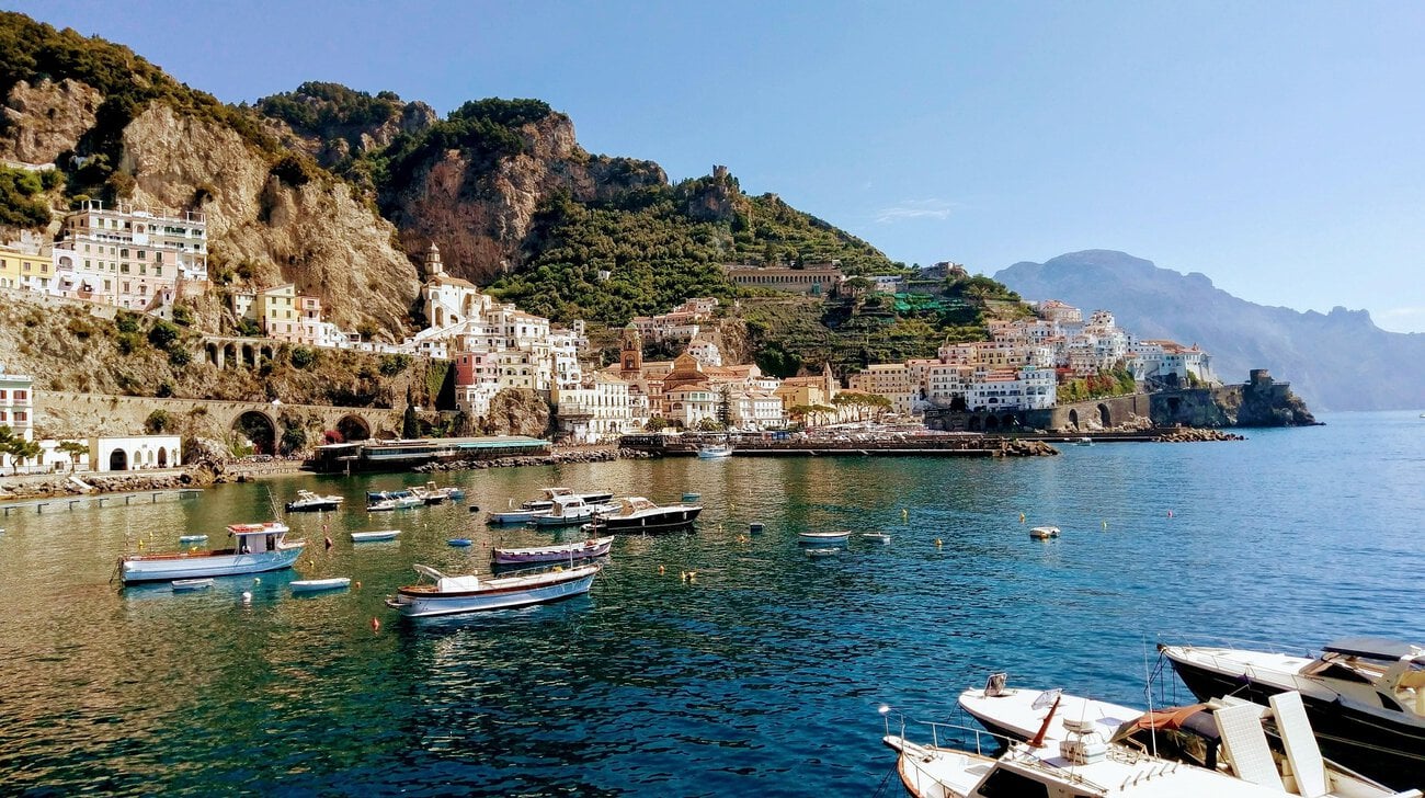 Amalfi Coast town with colourful buildings built into the cliffs above the sea