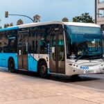 Blue EMT Malaga city bus operating on a route through Malaga city centre.