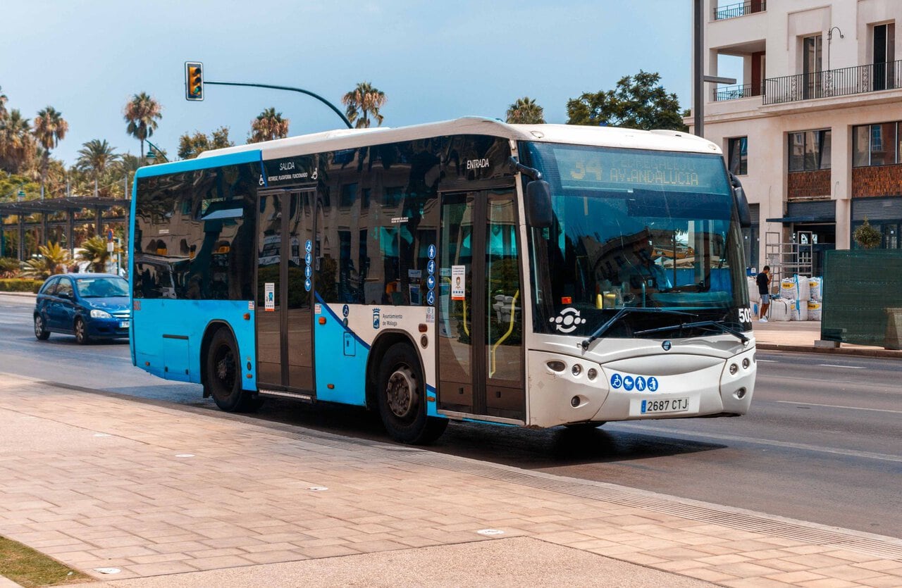 Blue EMT Malaga city bus operating on a route through Malaga city centre.