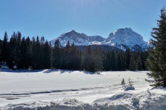 Frozen Black Lake surrounded by Durmitor mountains