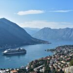 Cruise ship docked in Kotor Bay surrounded by dramatic mountains