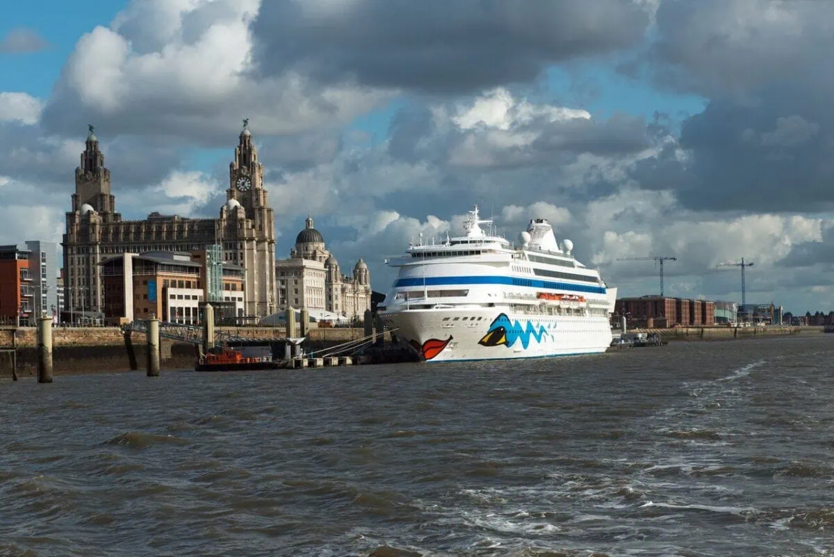 A cruise ship berthed at Liverpool Cruise Terminal beside the iconic Royal Liver Building on the River Mersey.