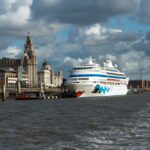 A cruise ship berthed at Liverpool Cruise Terminal beside the iconic Royal Liver Building on the River Mersey.