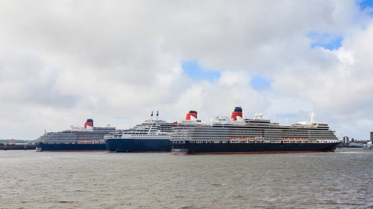 Cunard's Queen Mary 2, Queen Elizabeth and Queen Victoria sailing together on the River Mersey in Liverpool during a historic fleet gathering.