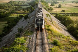 Modern passenger train travelling through the Montenegrin countryside