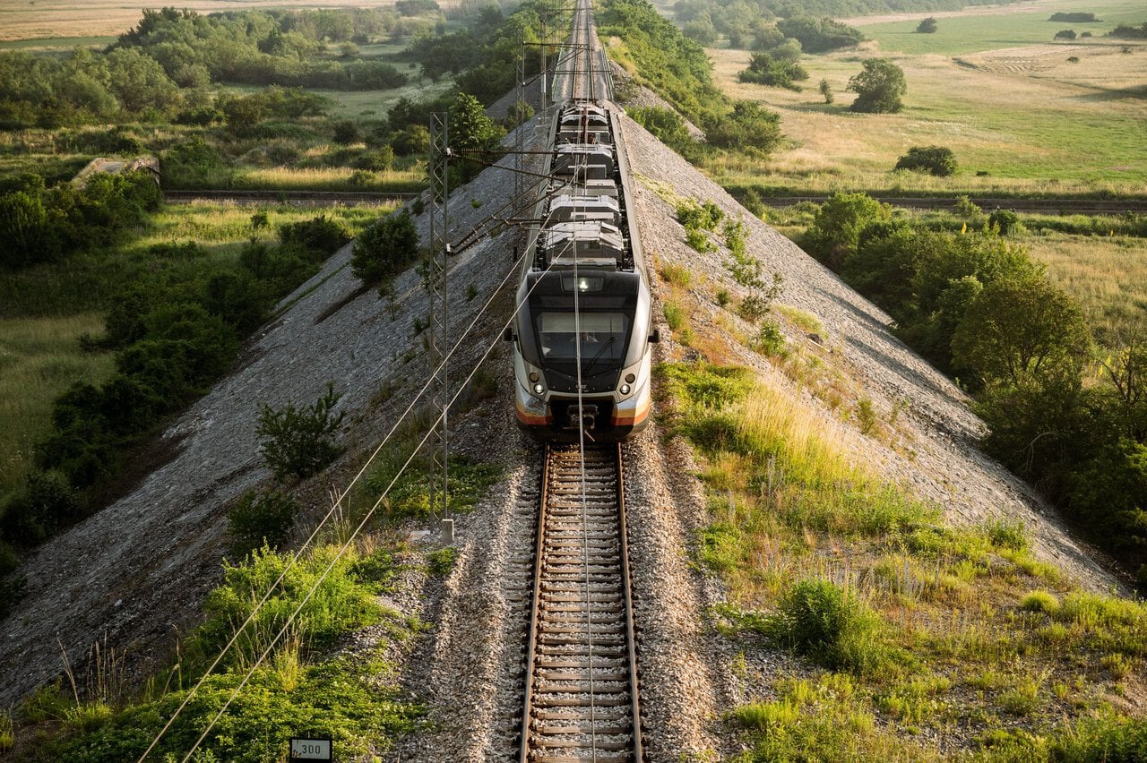 Modern passenger train travelling through the Montenegrin countryside