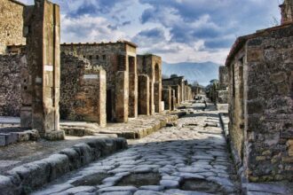 Ancient Roman street in Pompeii viewed towards Mount Vesuvius