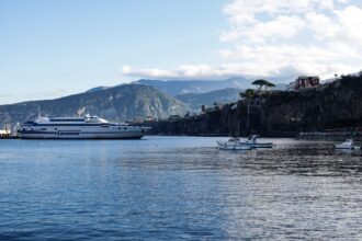 Ferry arriving at Sorrento Marina with cliffs and coastline in the background