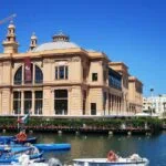 Teatro Margherita beside the waterfront and fishing boats in Bari, Italy.