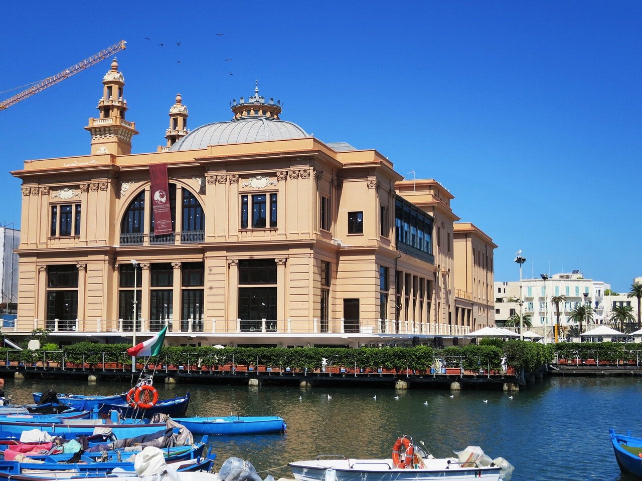Teatro Margherita beside the waterfront and fishing boats in Bari, Italy.