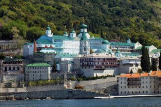 St Panteleimon Monastery on Mount Athos with its distinctive green domes overlooking the waterfront.