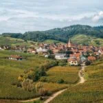 Scenic vineyard village surrounded by rolling hills on the Alsace Wine Route