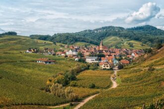 Scenic vineyard village surrounded by rolling hills on the Alsace Wine Route