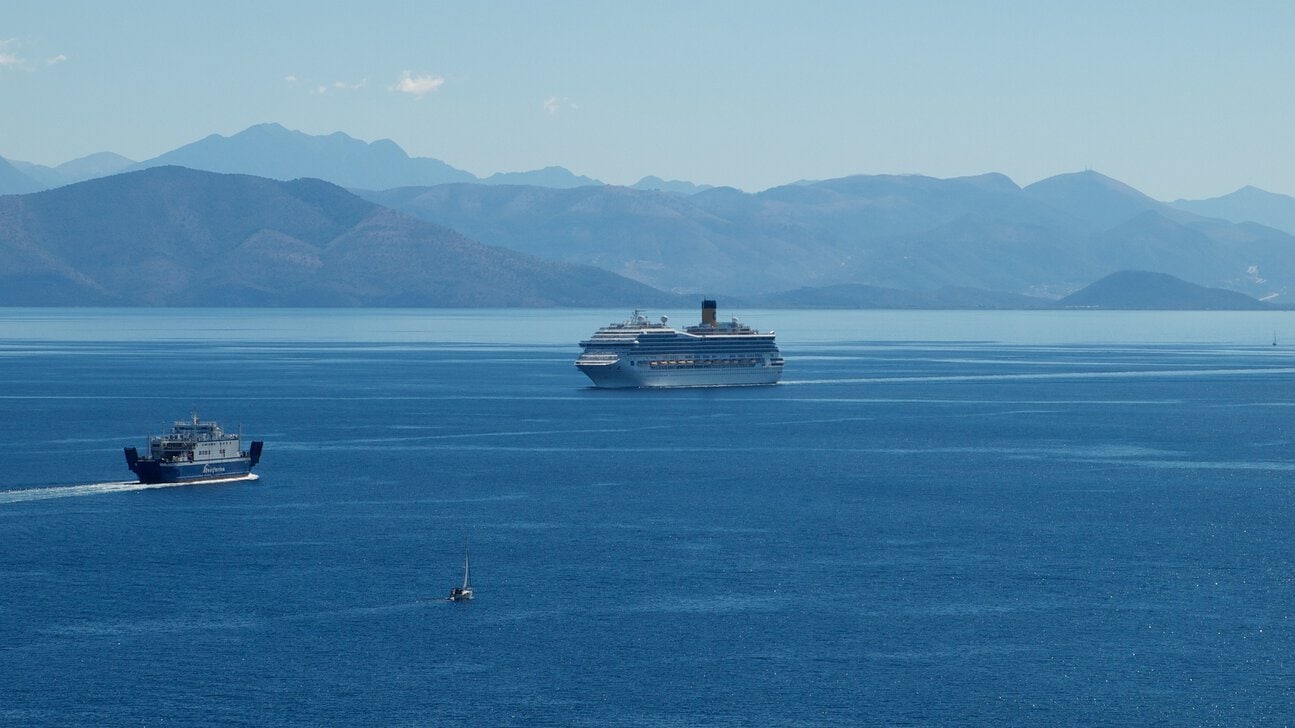 Passenger ferry and cruise ship sailing in the Ionian Sea near Corfu.