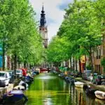 Traditional Amsterdam canal lined with historic houses and boats