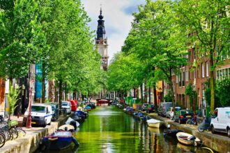 Traditional Amsterdam canal lined with historic houses and boats