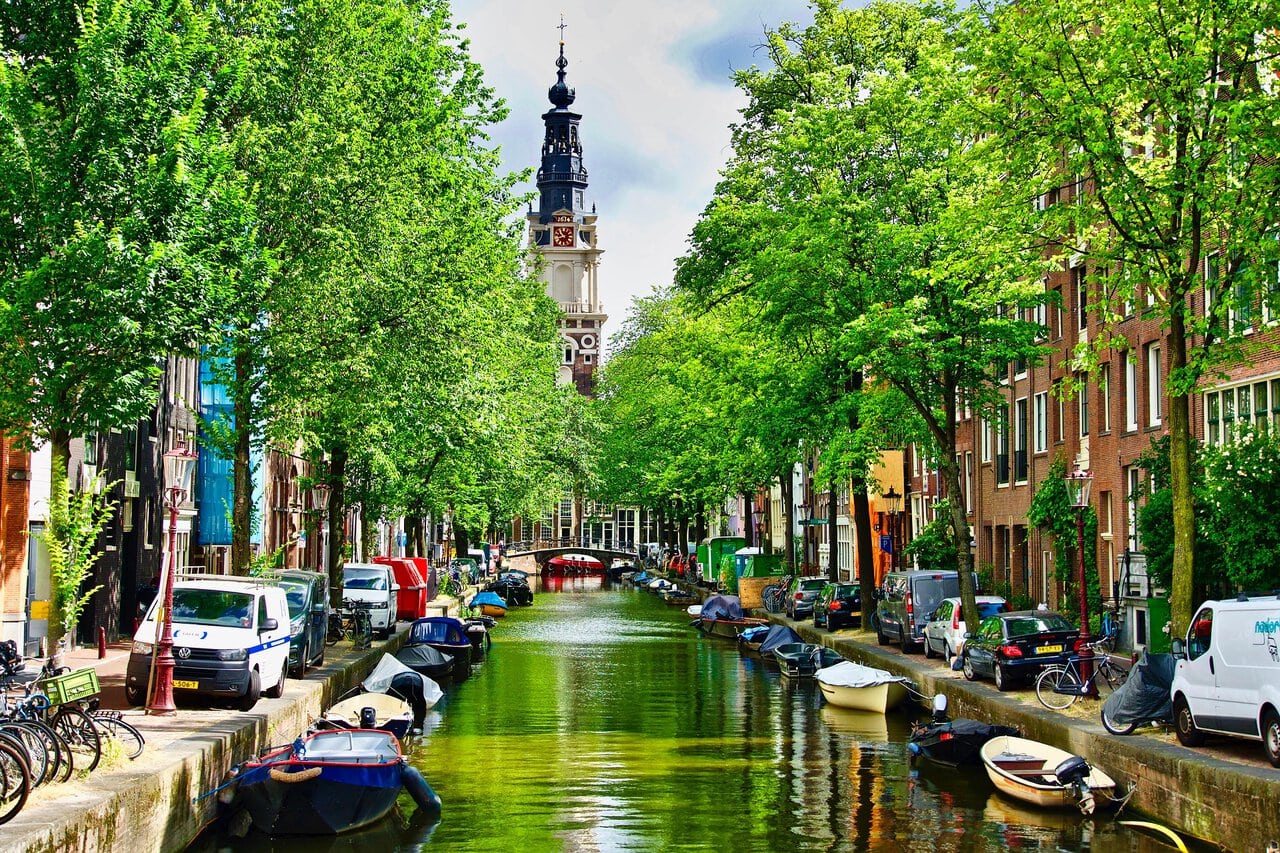Traditional Amsterdam canal lined with historic houses and boats