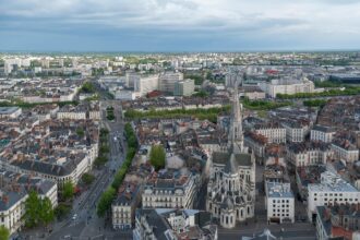 Aerial view of Nantes city centre with Saint Nicholas Church and surrounding streets.