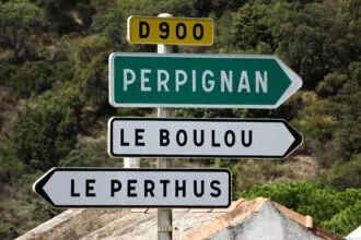 Road sign pointing towards Perpignan in southern France