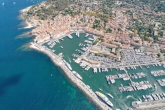 Colourful harbour of Saint-Tropez with luxury yachts and Provençal buildings on the French Riviera