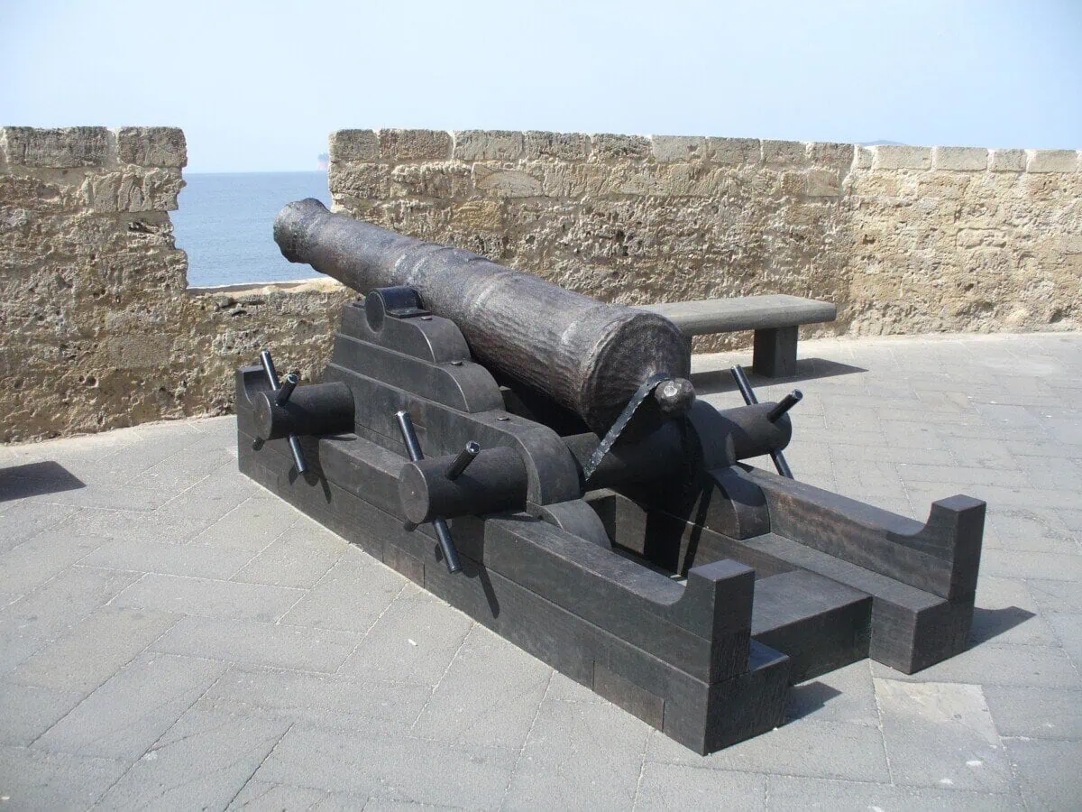 Historic cannon on Alghero city walls overlooking the sea