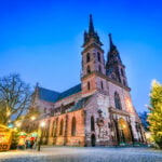Basel Christmas Market beside Basel Minster with a decorated Christmas tree