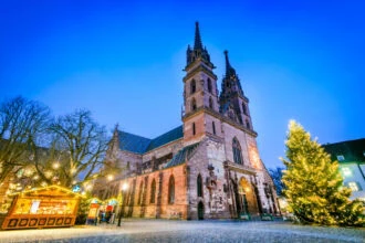 Basel Christmas Market beside Basel Minster with a decorated Christmas tree