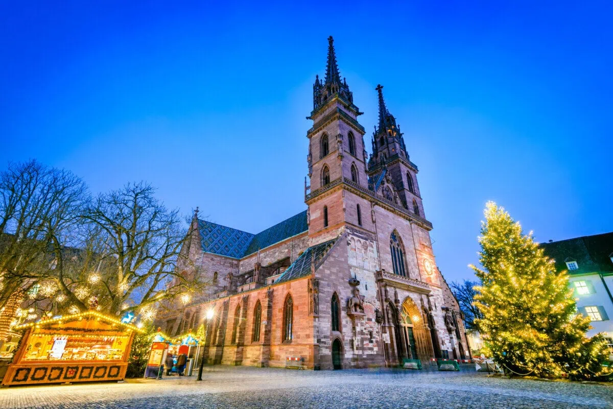 Basel Christmas Market beside Basel Minster with a decorated Christmas tree
