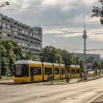 Yellow Berlin tram with the Fernsehturm in the background