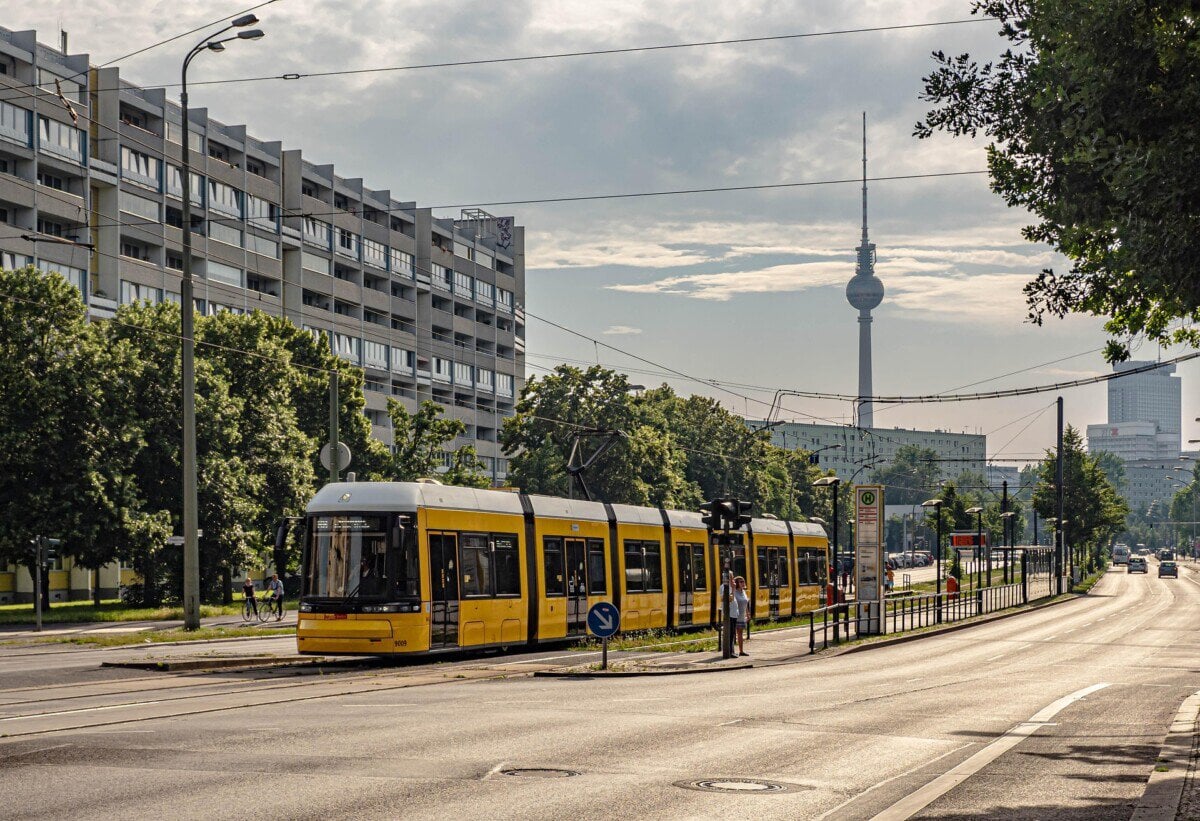 Yellow Berlin tram with the Fernsehturm in the background