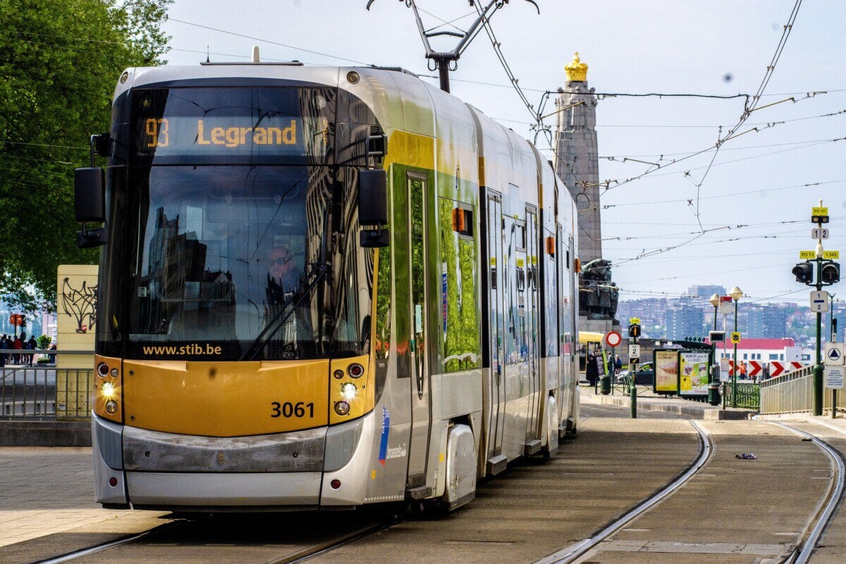 STIB tram travelling through Brussels with overhead power lines