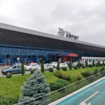 Chișinău International Airport terminal entrance with taxis outside in Moldova