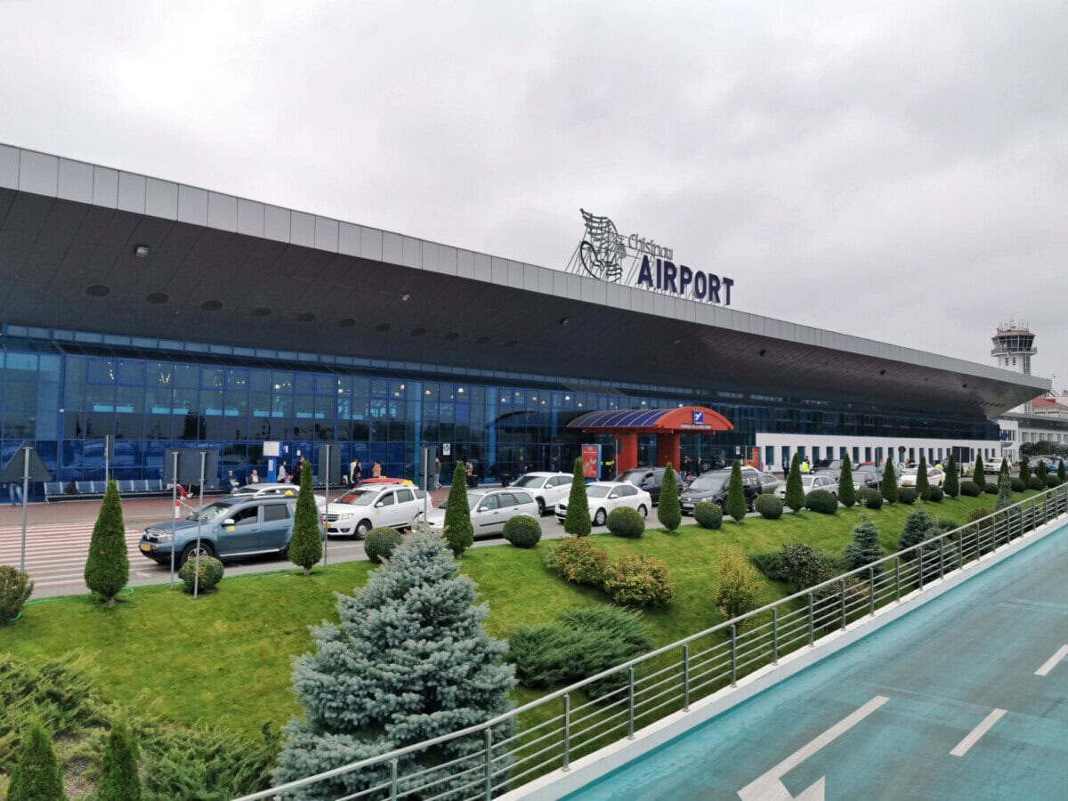 Chișinău International Airport terminal entrance with taxis outside in Moldova