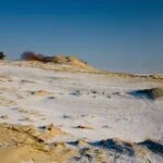 Snow-dusted sand dunes on the Curonian Spit in Lithuania