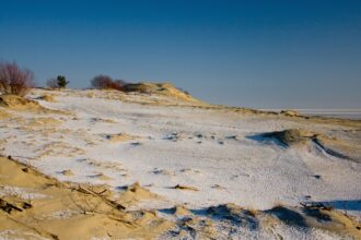 Snow-dusted sand dunes on the Curonian Spit in Lithuania