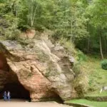 Gutmanis Cave in Gauja National Park near Sigulda Latvia surrounded by woodland