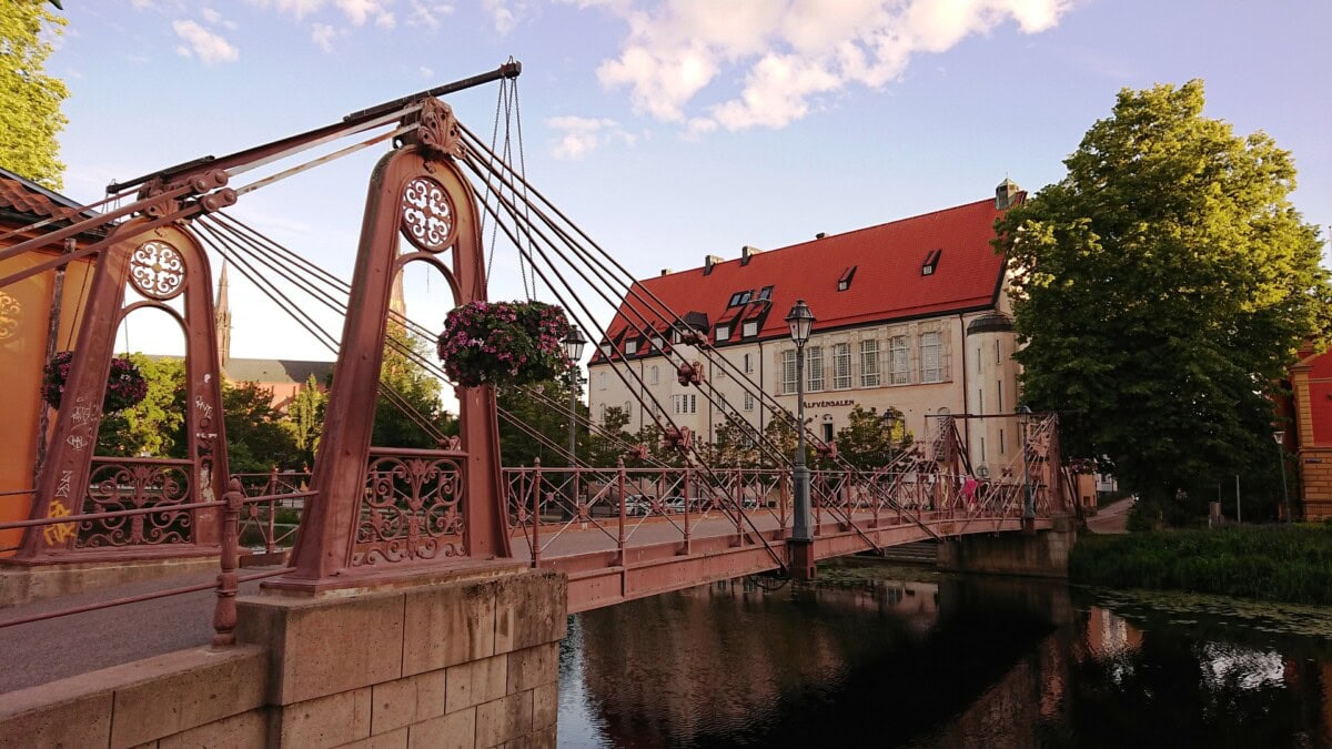 Ornate historic bridge over a river in a Swedish town on a day trip from Stockholm