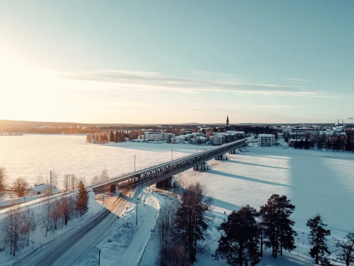 Railway bridge crossing the frozen Kemijoki River in Rovaniemi, Finnish Lapland