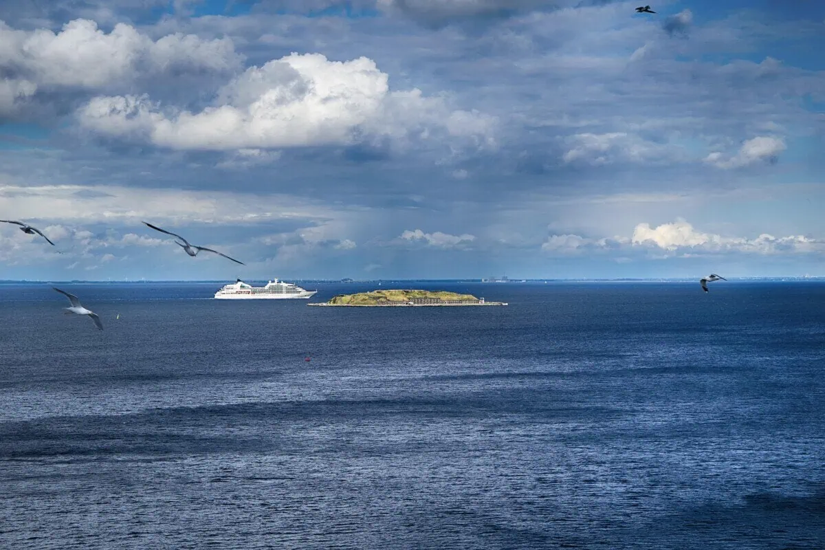 Ferry sailing off the coast near Copenhagen under a dramatic blue sky