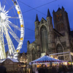 Ferris wheel and Christmas market beside Saint Nicholas' Church in Ghent, Belgium
