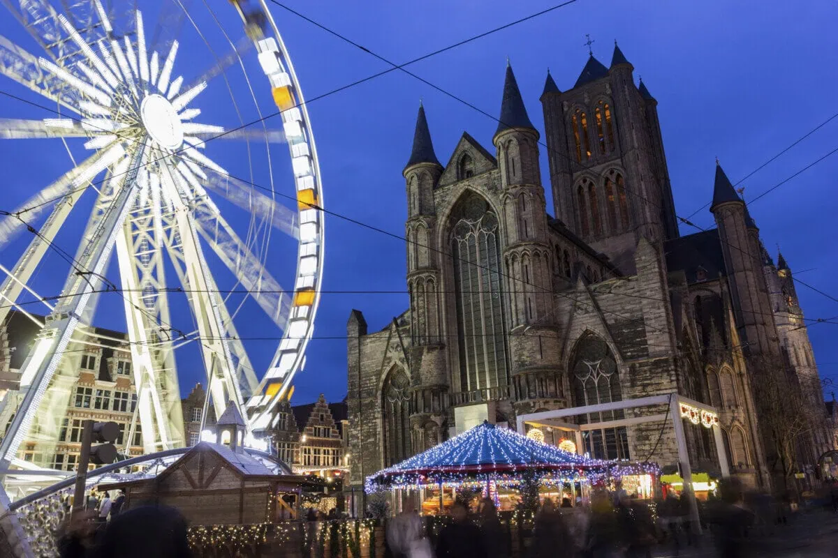 Ferris wheel and Christmas market beside Saint Nicholas' Church in Ghent, Belgium