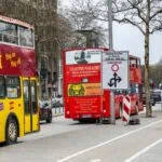 Hop-on hop-off sightseeing buses on a street in central Hamburg